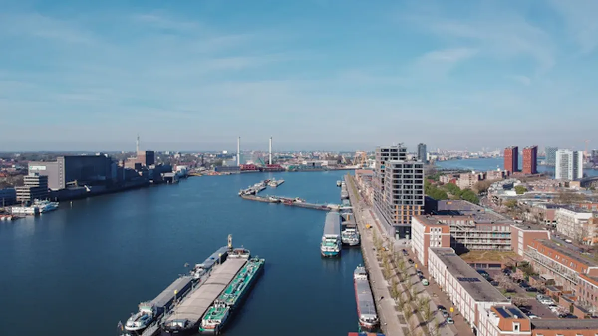 Large oil tankers docked at Rotterdam port facilities with loading infrastructure